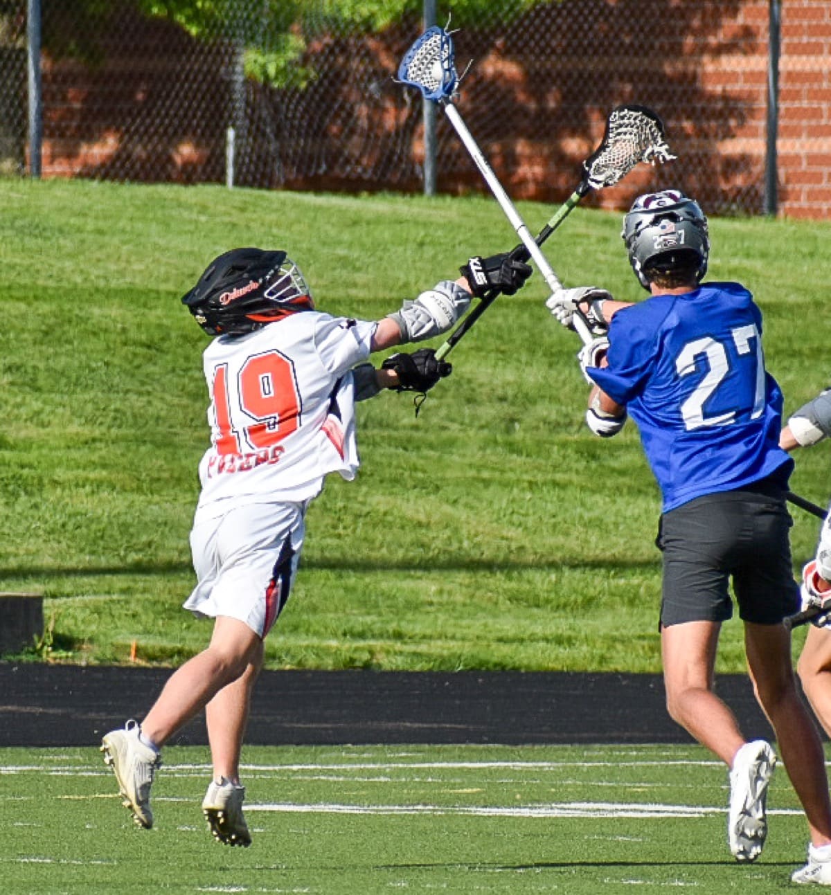 High school lacrosse players battling for the ball during a game in Central Ohio