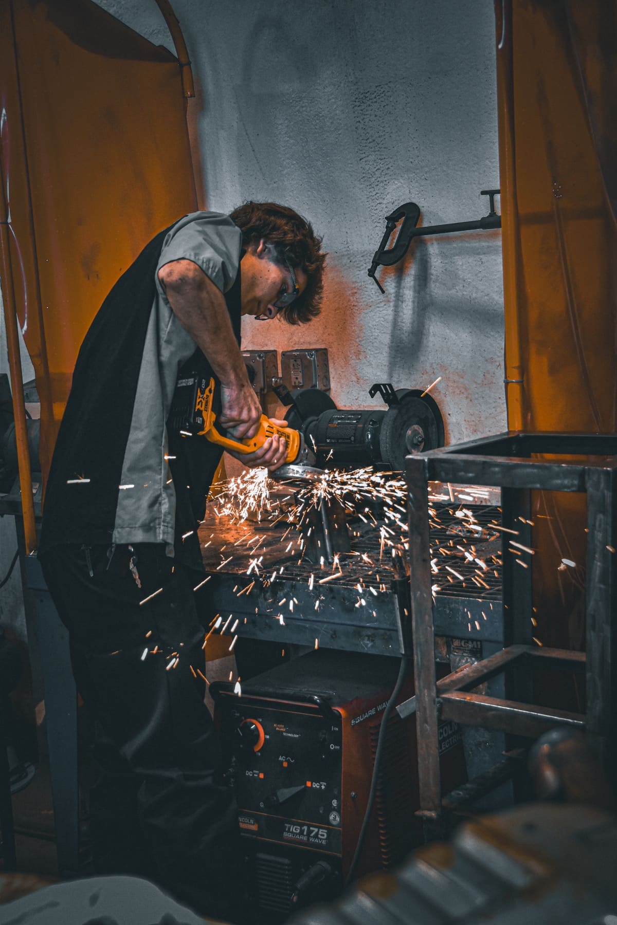 Senior welding in a shop, sparks lit up, for a session built around his trade
