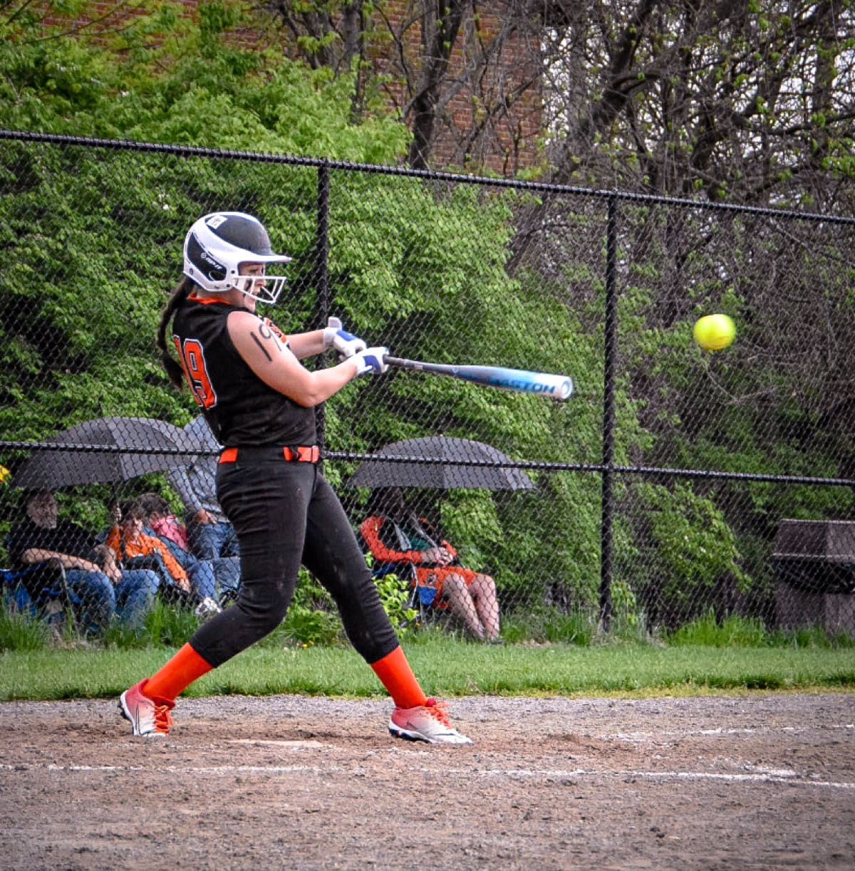 Softball batter swinging at a pitch during a game in Delaware, Ohio