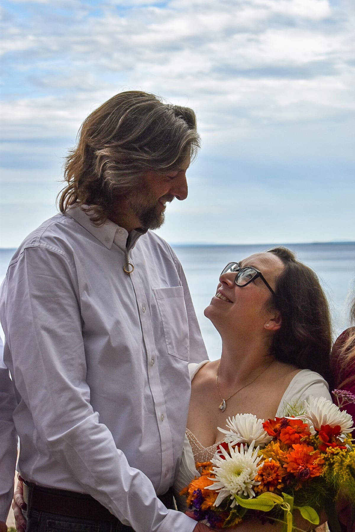 Couple sharing a look on the beach during a lakeside celebration