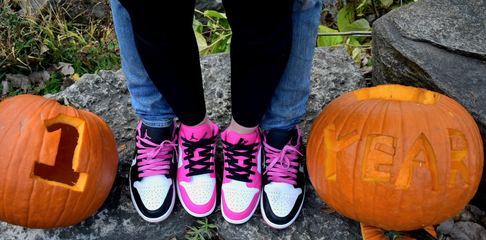 Anniversary photo showing couple's feet in matching Air Jordan sneakers with carved pumpkins reading '1 YEAR'